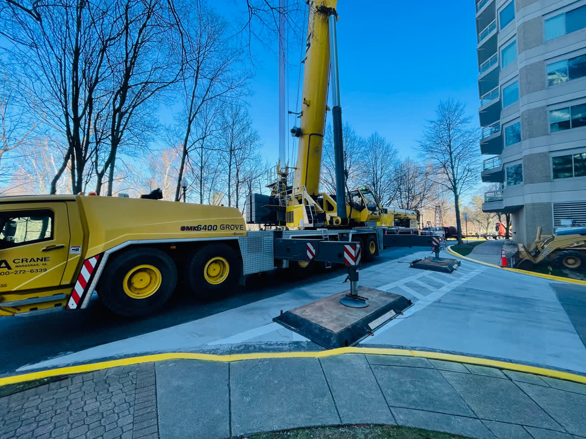 Crane lifting equipment onto a commercial roof