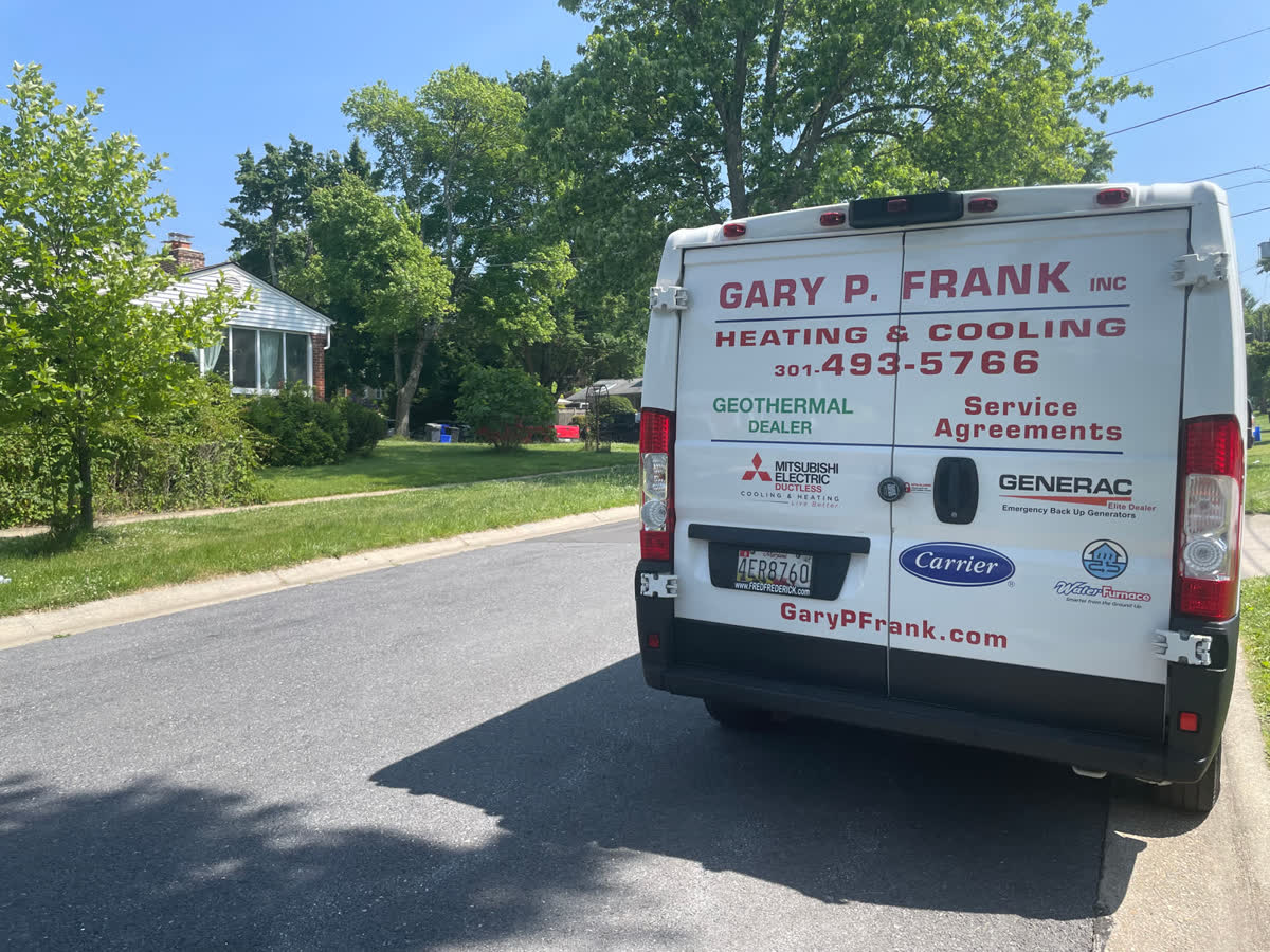 A Gary P. Frank service van parked on a residential street